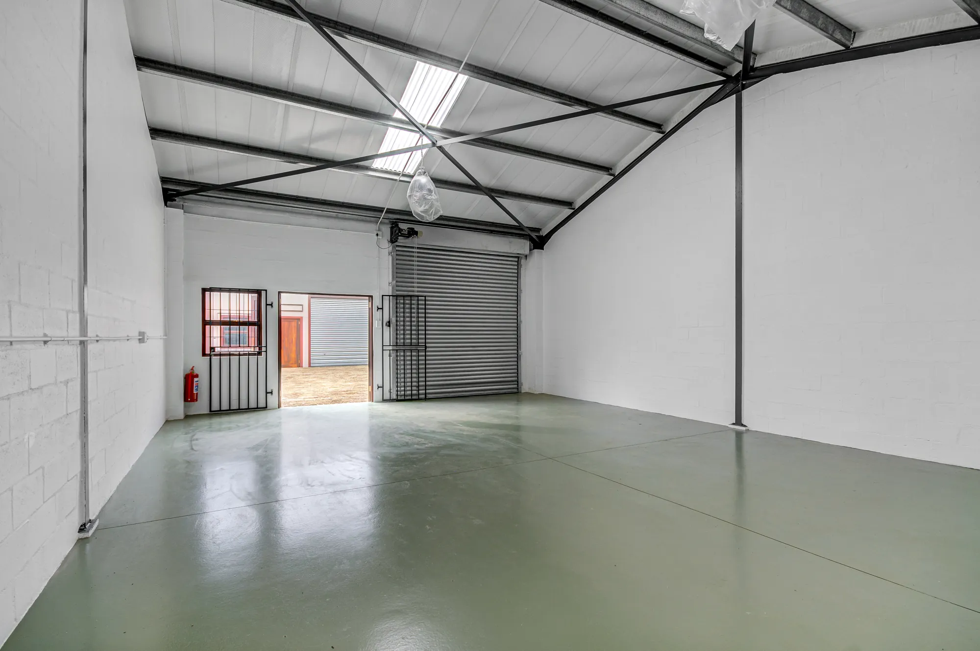 Inside a unit, looking towards the roller door and the windows