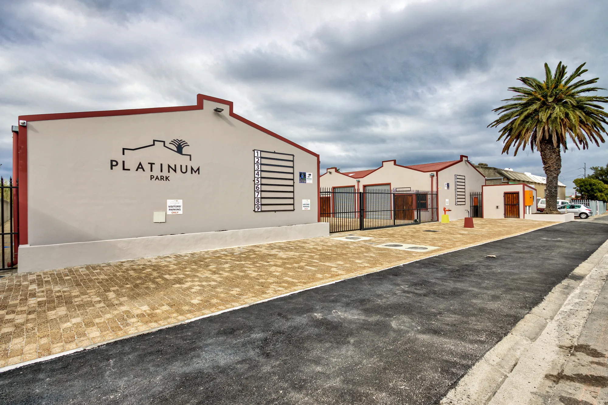 The Platinum Park entrance, with the park sign on the end wall and a palm tree